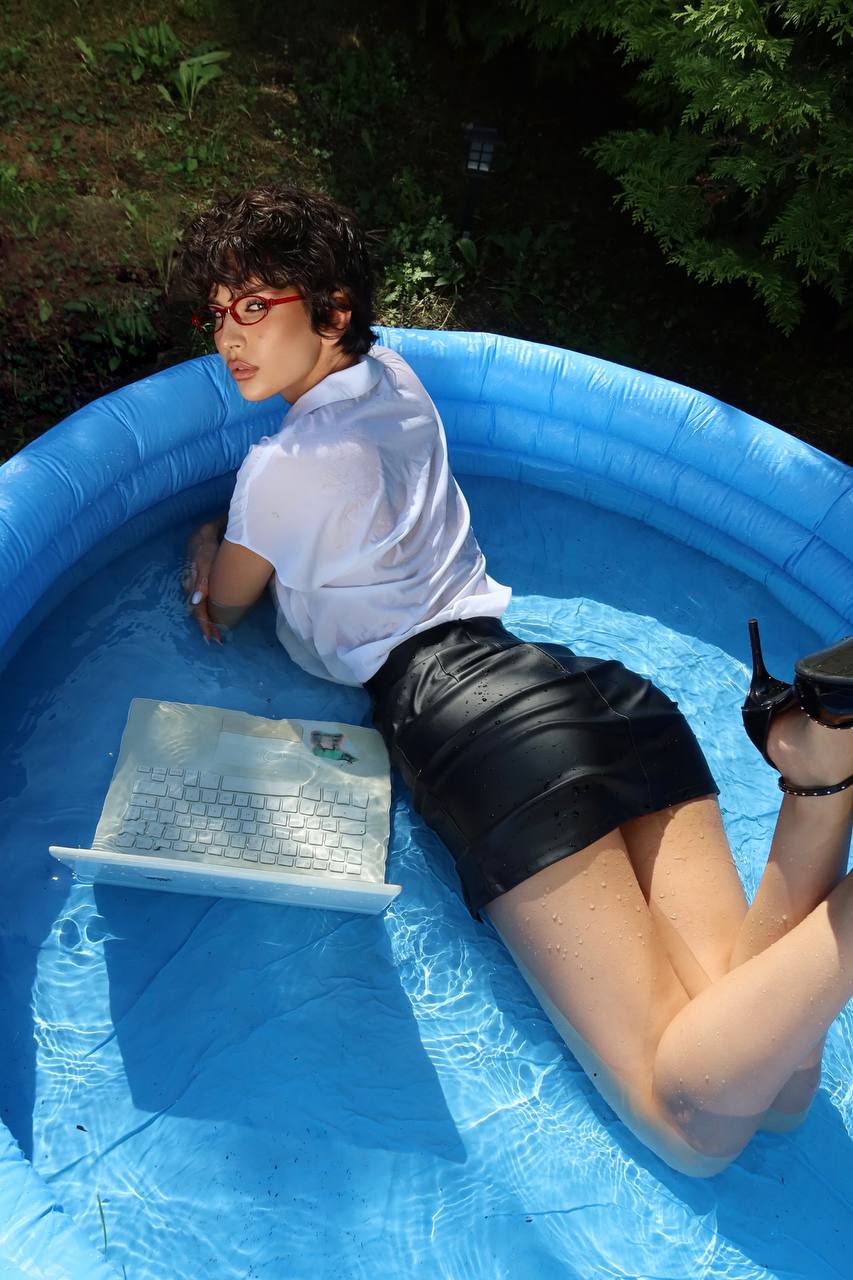 Горячая фотка с красоткой mugretnug в чёрной мини юбке, красных очках и лёжа в бассейне.